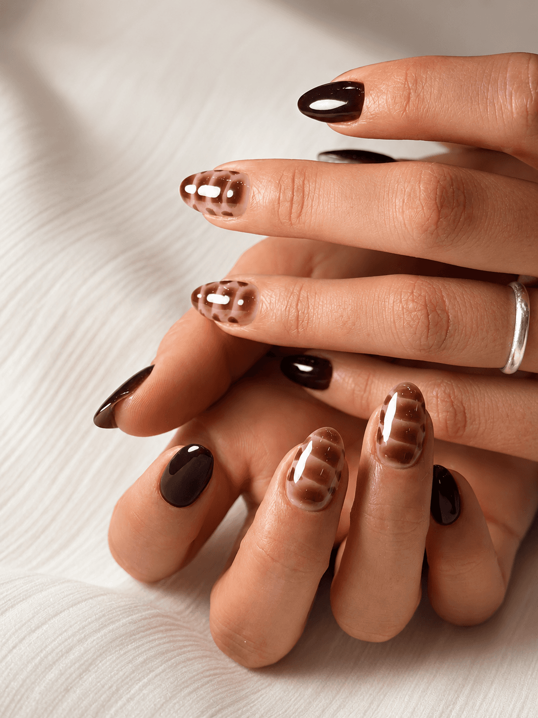 Brown glossy nails with translucent shell-inspired art