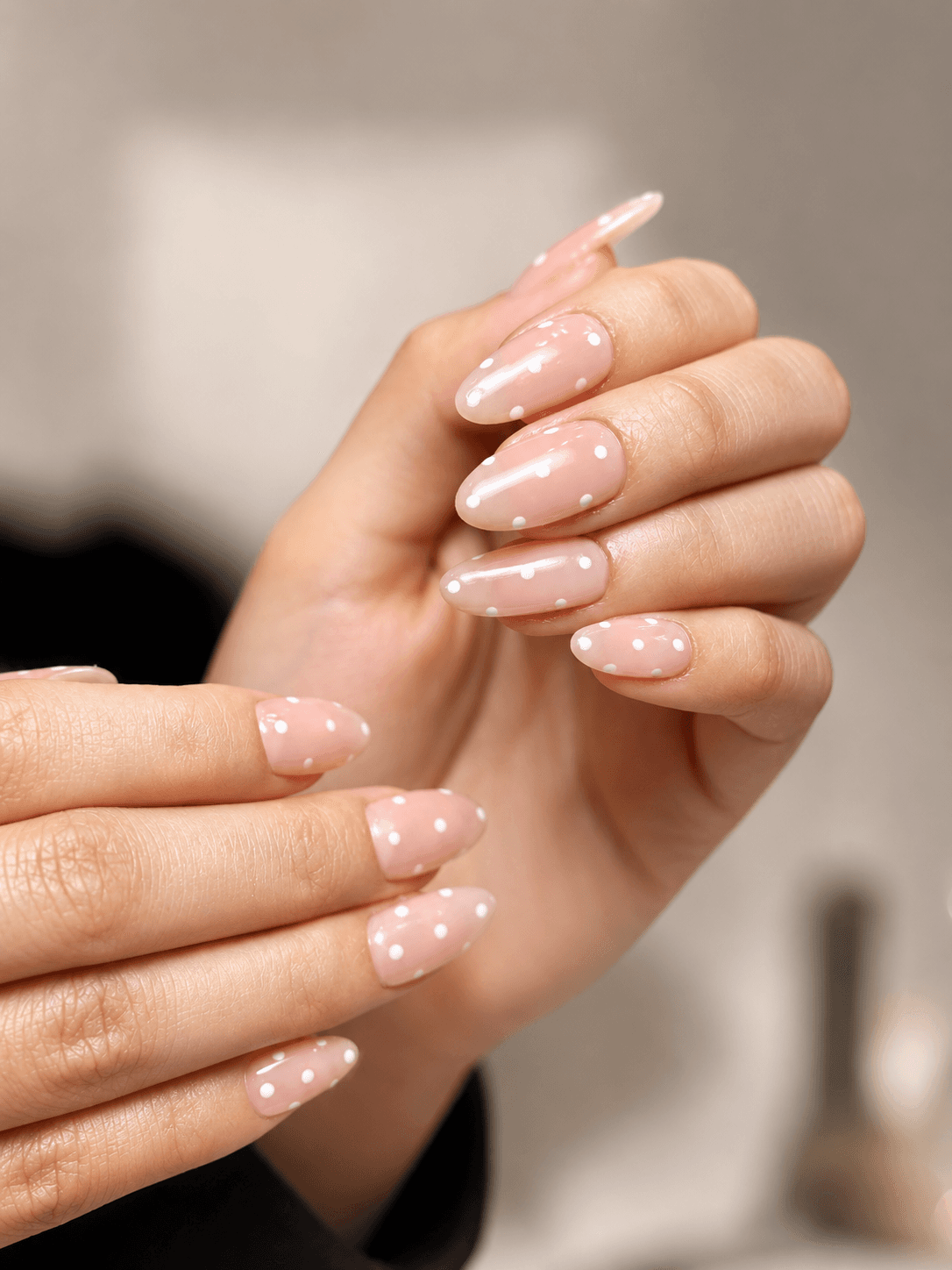 Sheer nude nails with white polka dot detailing
